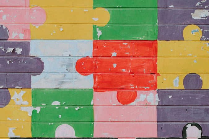 A wall painted with multicolored jigsaw pieces